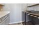 Convenient laundry room featuring gray cabinets, countertops, and modern washer and dryer at 11426 Box Turtle Ct, Parker, CO 80134