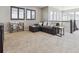 Spacious living room featuring a comfortable sectional sofa and plenty of natural light from the windows at 11426 Box Turtle Ct, Parker, CO 80134