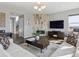 Comfortable living room featuring a fireplace, modern lighting, and hardwood flooring at 11426 Box Turtle Ct, Parker, CO 80134