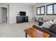 Cozy living room with plush carpet, media center, and a comfortable leather sofa at 11426 Box Turtle Ct, Parker, CO 80134