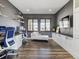 A stylish home office with wood floors, built-in cabinets, and a cozy chaise lounge at 11426 Box Turtle Ct, Parker, CO 80134