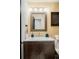 Charming bathroom features a wooden vanity with marble countertop and bronze faucet at 3130 S Krameria St, Denver, CO 80222