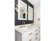 Modern bathroom features a double sink vanity with stylish gold fixtures and black accent wall at 3130 S Krameria St, Denver, CO 80222