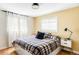 Cozy bedroom with natural light, hardwood floors, a comfortable bed, and modern furnishings at 3130 S Krameria St, Denver, CO 80222