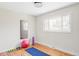 Neutral workout room with mirror, large window, blue yoga mat, exercise ball and weights at 3130 S Krameria St, Denver, CO 80222
