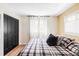 Comfortable bedroom featuring a plush bed, bright windows, and closet space at 3130 S Krameria St, Denver, CO 80222