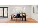 Bright dining room with a large window, wooden table, and an array of stylish chairs at 3130 S Krameria St, Denver, CO 80222