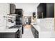 Modern kitchen featuring black cabinets, white countertops, and a stylish backsplash at 3130 S Krameria St, Denver, CO 80222