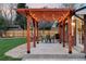 Relaxing backyard pergola with a table set, chairs, and hammock swings at 3130 S Krameria St, Denver, CO 80222