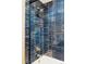 Shower features blue tiled walls, black trim and gold hardware at 3130 S Krameria St, Denver, CO 80222