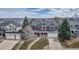 A bird's eye view of a two-story house with a well maintained yard in a suburban neighborhood at 10046 Brisbane Ln, Highlands Ranch, CO 80130