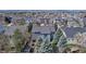 Aerial view of the home and neighborhood with mature trees and mountain views at 10046 Brisbane Ln, Highlands Ranch, CO 80130