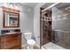 Bathroom featuring a shower with decorative tile work and a wood vanity at 10046 Brisbane Ln, Highlands Ranch, CO 80130