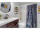 Modern bathroom with a stylish vanity, decorative shower curtain, and contemporary fixtures at 10046 Brisbane Ln, Highlands Ranch, CO 80130