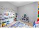 Fun bedroom features toy storage, Lego decor and colorful road map rug at 10046 Brisbane Ln, Highlands Ranch, CO 80130