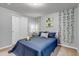 Cozy bedroom with a comfortable bed, closet, and botanical wall decor at 10046 Brisbane Ln, Highlands Ranch, CO 80130