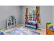 Brightly decorated bedroom with colorful curtains, toy storage, and a playful road map rug at 10046 Brisbane Ln, Highlands Ranch, CO 80130