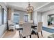 Formal dining area with a large table, sophisticated chairs, and ample natural light at 10046 Brisbane Ln, Highlands Ranch, CO 80130