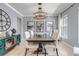 Elegant dining room with modern lighting, neutral color scheme, and statement artwork at 10046 Brisbane Ln, Highlands Ranch, CO 80130