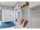 Bright entryway with custom storage, a bench, and easy access to other areas of the home at 10046 Brisbane Ln, Highlands Ranch, CO 80130
