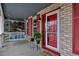 Inviting front porch with a cozy swing, decorative plants, and a welcoming entrance at 10046 Brisbane Ln, Highlands Ranch, CO 80130