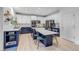 Modern kitchen with navy blue and white cabinets, stainless steel appliances, and large island at 10046 Brisbane Ln, Highlands Ranch, CO 80130