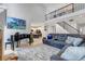 Open-concept living room with grand piano and view of staircase to upper level at 10046 Brisbane Ln, Highlands Ranch, CO 80130