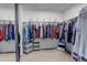 A large walk-in closet with a variety of clothing hung neatly on rods at 10046 Brisbane Ln, Highlands Ranch, CO 80130