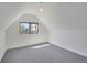 Light-filled attic room featuring a window, providing ample natural light, and neutral finishes at 1601 Robb St, Lakewood, CO 80215