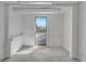 Finished basement featuring a unique door to the outside area and ample lighting at 1601 Robb St, Lakewood, CO 80215