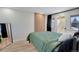 Bright bedroom with a private balcony, closet and stylish wall mirror at 1601 Robb St, Lakewood, CO 80215