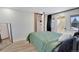 Stylish bedroom featuring private deck access and closet for ample storage at 1601 Robb St, Lakewood, CO 80215