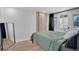 Modern bedroom with private deck access and stylish wood accent wall at 1601 Robb St, Lakewood, CO 80215