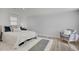 Bright bedroom with a neutral color palette, plush rug, and ample lighting at 1601 Robb St, Lakewood, CO 80215