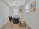 Bright dining area with modern lighting, stylish chairs, and a sleek table, lit by a window at 1601 Robb St, Lakewood, CO 80215