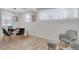 Bright and modern dining area with stylish furnishings and plenty of natural light from large window with a small chair in the corner at 1601 Robb St, Lakewood, CO 80215