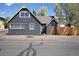 Charming home exterior featuring gray siding, complemented by well-maintained landscaping and a welcoming front entrance at 1601 Robb St, Lakewood, CO 80215