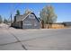 Exterior view of a well-maintained home with modern siding, a neatly landscaped yard, and a paved driveway at 1601 Robb St, Lakewood, CO 80215