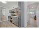 Well-equipped kitchen with modern appliances, gray cabinets, and a view into the living room at 1601 Robb St, Lakewood, CO 80215