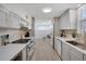 Stylish kitchen featuring stainless steel appliances, gas range, and ample counter space, and gray cabinets at 1601 Robb St, Lakewood, CO 80215