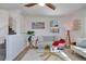 Bright living room featuring a ceiling fan, large window, and modern decor and a set of stairs to the second story at 1601 Robb St, Lakewood, CO 80215