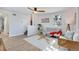 Bright living room featuring a ceiling fan, large window, and modern decor and a set of stairs to the second story at 1601 Robb St, Lakewood, CO 80215