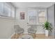 Cozy sitting area with stylish gray chairs, ottoman and bright windows at 1601 Robb St, Lakewood, CO 80215
