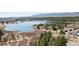 Scenic aerial view of the community featuring a lake, trees, and mountain views at 1890 Bel Lago Vw, Monument, CO 80132