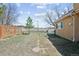 The backyard boasts a grassy area, patio with seating, and privacy fence at 1890 Bel Lago Vw, Monument, CO 80132
