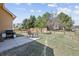 The backyard features a patio with outdoor seating, a grill, and a fenced lawn at 1890 Bel Lago Vw, Monument, CO 80132