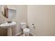 Powder room with pedestal sink and toilet at 1890 Bel Lago Vw, Monument, CO 80132