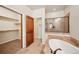 Elegant bathroom with a soaking tub, walk-in shower, tile flooring, and a walk-in closet at 1890 Bel Lago Vw, Monument, CO 80132