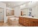 Bathroom featuring a soaking tub, walk-in shower, tile flooring, and dual sinks with granite counters at 1890 Bel Lago Vw, Monument, CO 80132