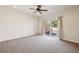 Spacious bedroom with neutral carpet, ceiling fan, and access to a private outdoor patio at 1890 Bel Lago Vw, Monument, CO 80132